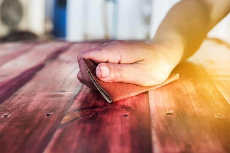 Hand,Sanding,And,Smoothing,Red,Wooden,With,Sandpaper.