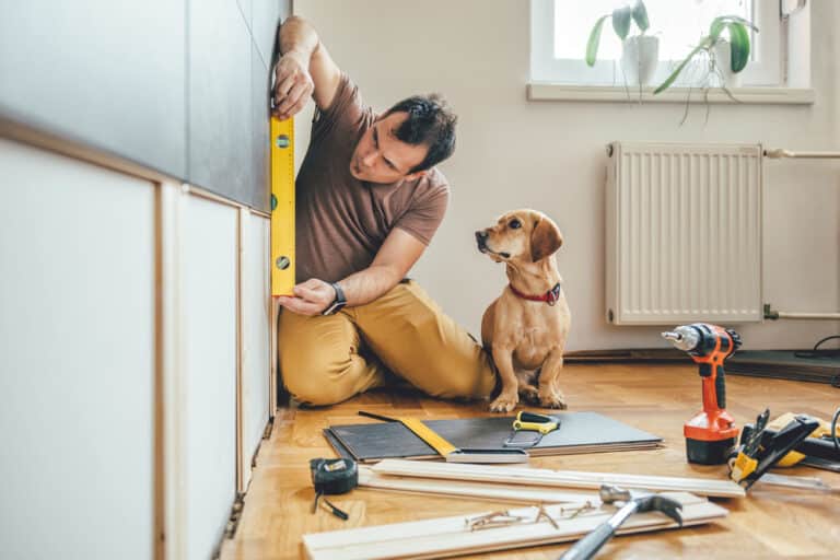 Man,Doing,Renovation,Work,At,Home,Together,With,His,Small