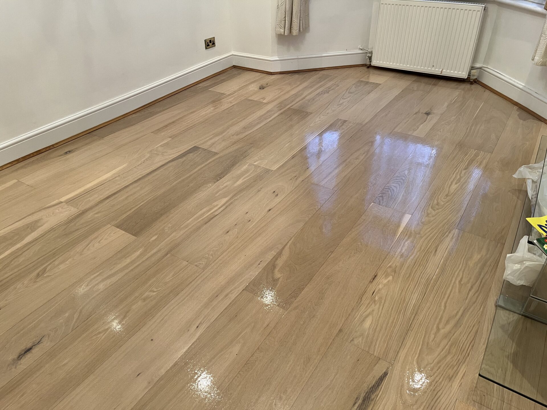 Spot Repair on oak engineered wood plank floor with blended top-up coats, showing a smooth, even gloss after localised restoration