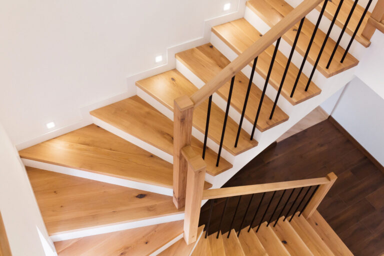 Modern oak hardwood staircase after Stair Tread Sanding, with wide timber treads and matching oak hardwood floor, creating a bright, contemporary look.