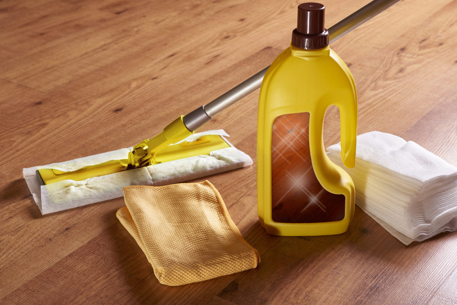 The 5-Minute Spill Test preparation on an oak strip hardwood floor—aftercare cleaning kit with spray cleaner, flat mop and microfibre cloth to ensure accurate results.