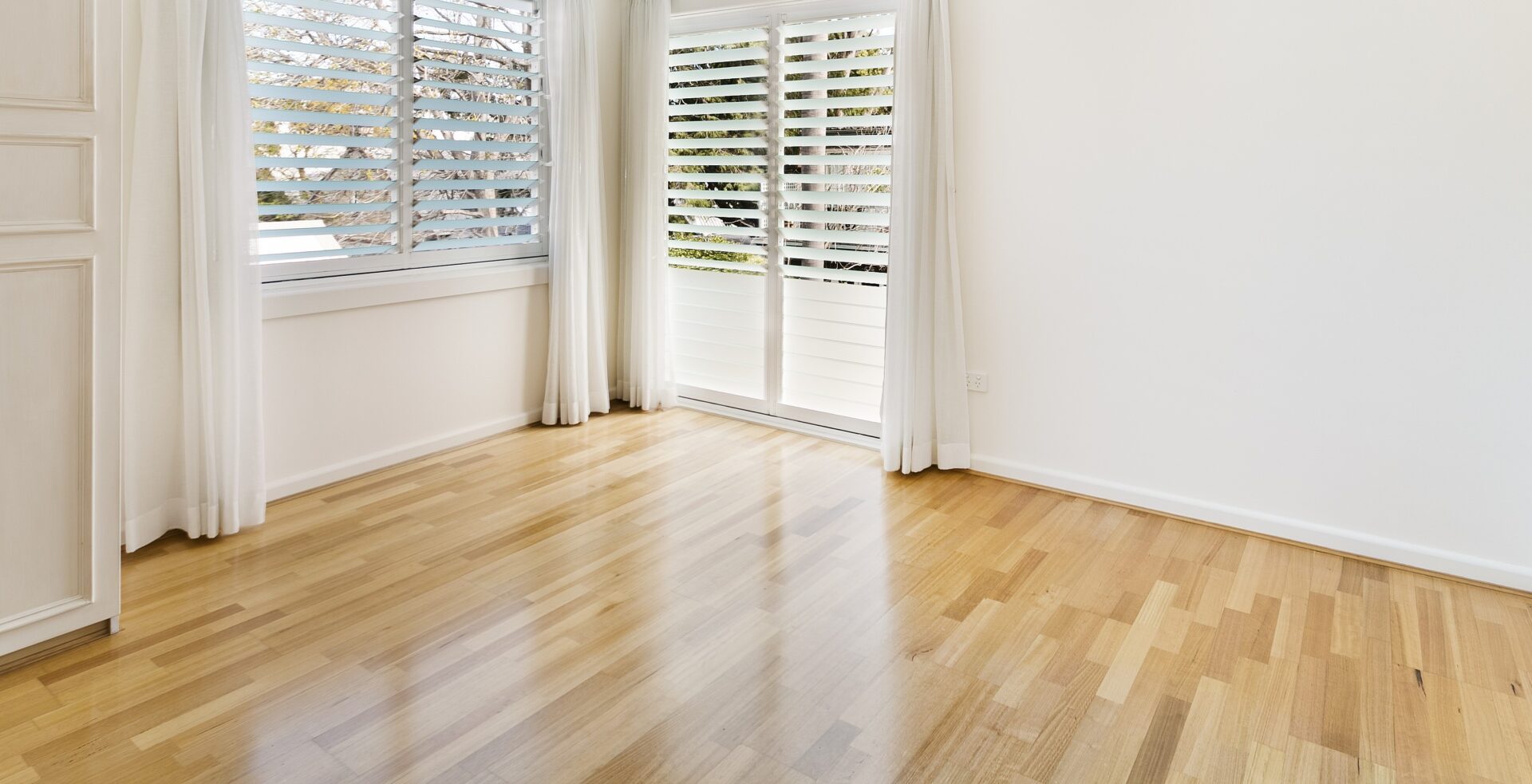 The “No-Yellow” Oak System on engineered oak flooring—natural, pale tone with a soft satin sheen in a bright room with shutters (Floor name: Engineered Oak Living Space; Type: Engineered European Oak, satin finish).