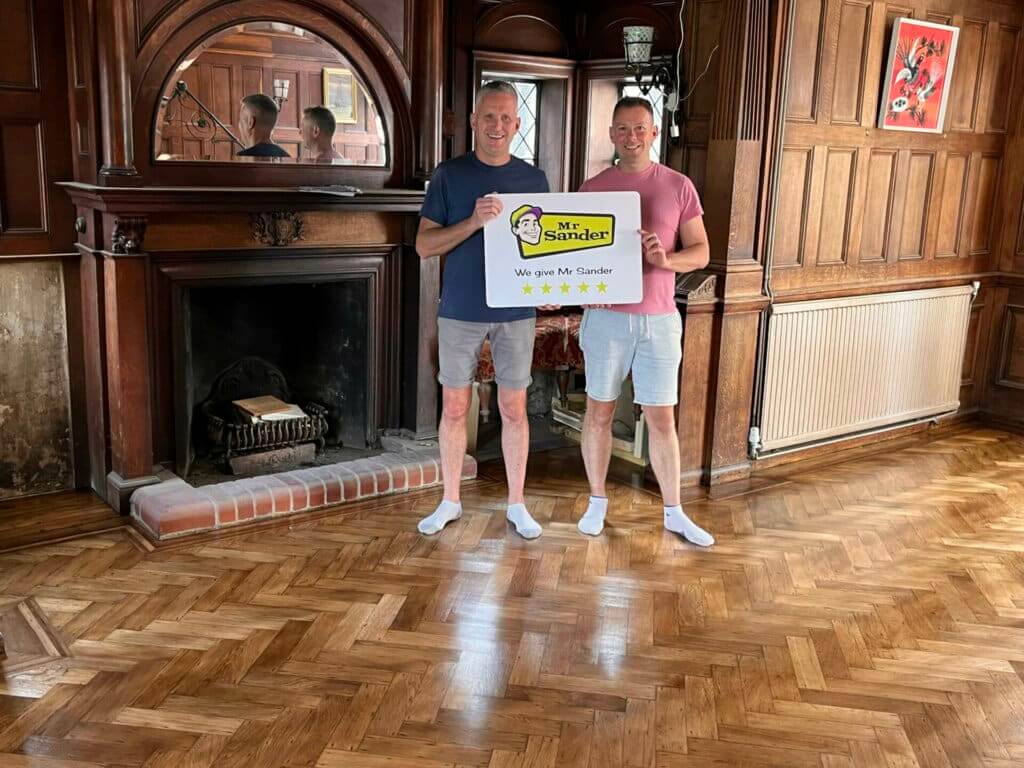 Delighted clients in Doune (FK16) standing on newly sanded and polished floors by Mr Sander®️, enjoying the enchanting results.