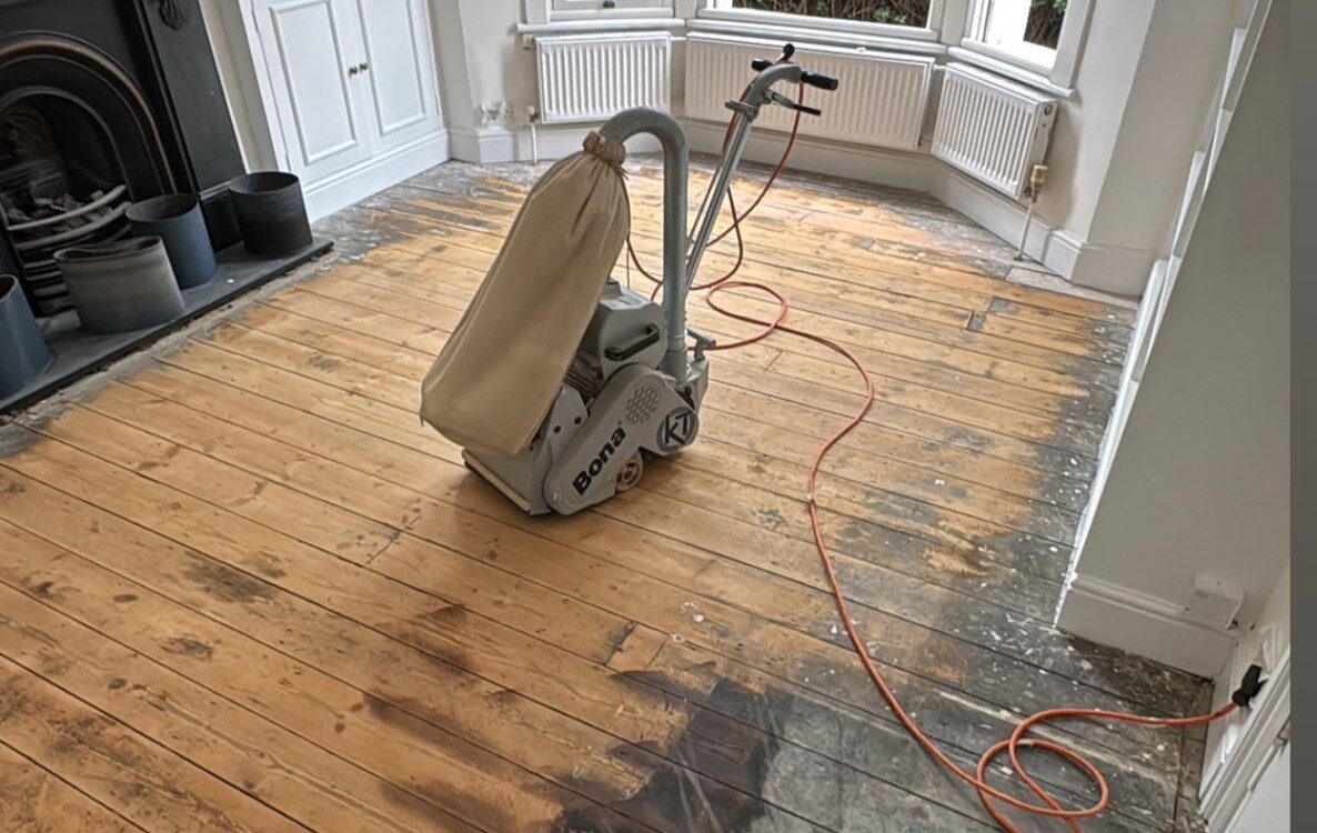 Victorian Pine Floor Sanding in progress using a Bona belt sander on original solid pine floorboards.