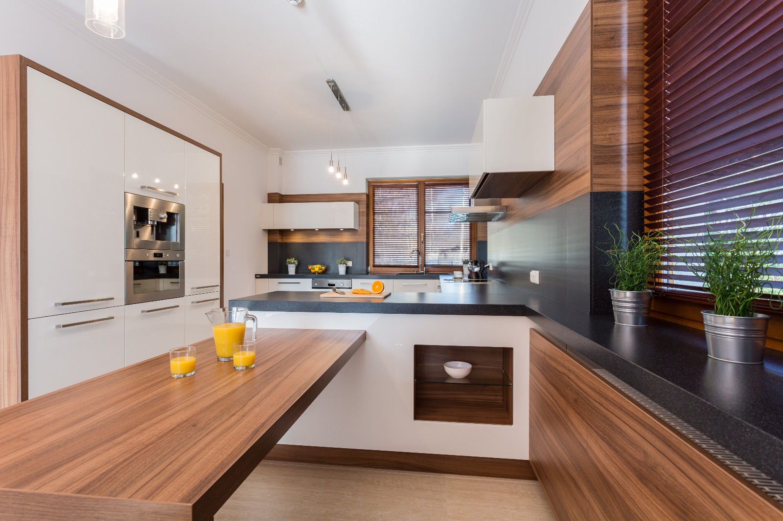 Modern kitchen after Worktop Sanding in London, featuring smooth wooden worktops, dark laminate detail and a light porcelain tiled floor for a clean, contemporary look.